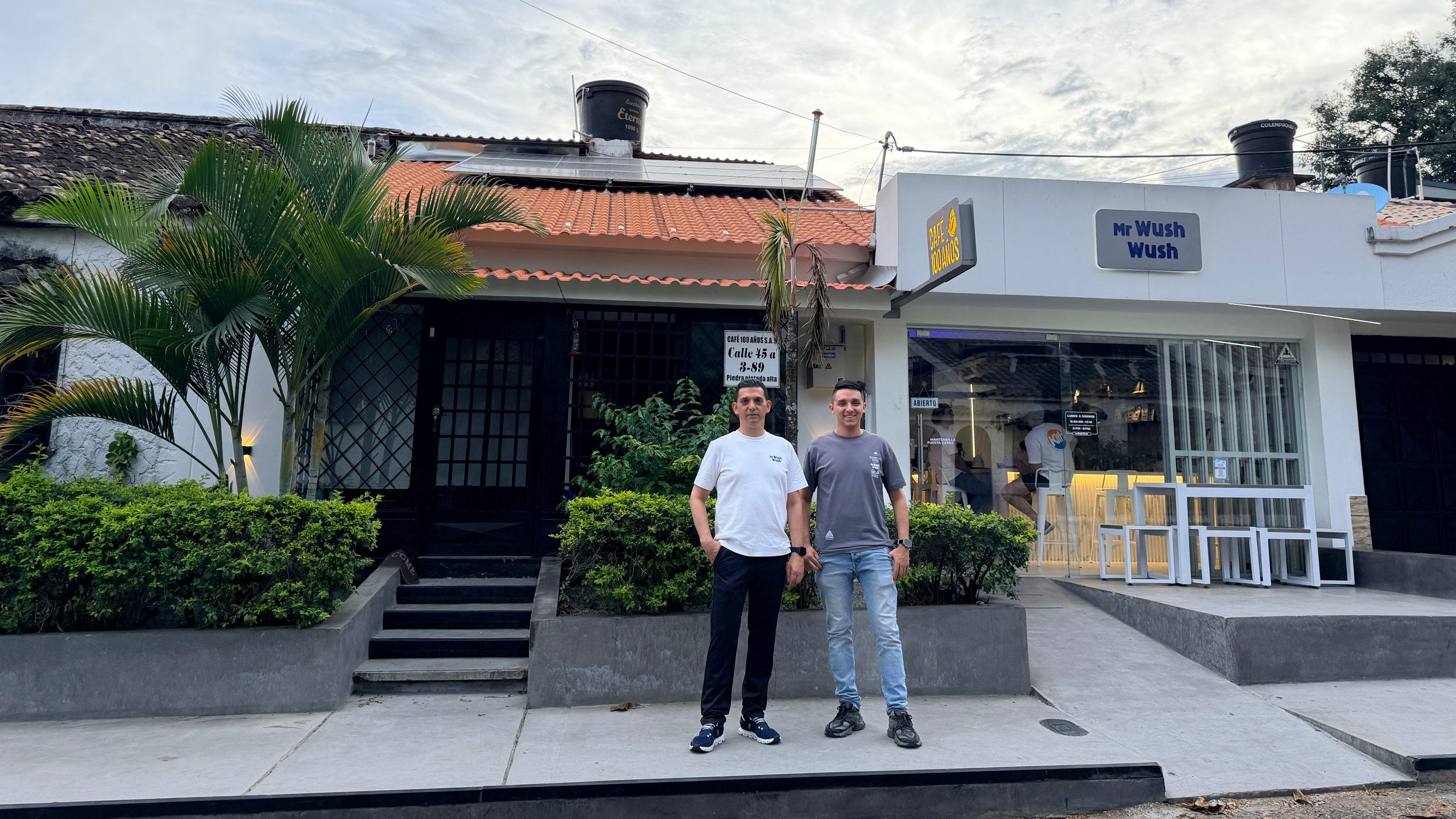 Vater Newerly Gutiérrez mit Sohn Roberth (19)vor dem Kaffee-Geschäft der Familie. Auf dem Dach: Solarpaneele. Damit versucht das Familienunternehmen, die STromkosten zu senken.