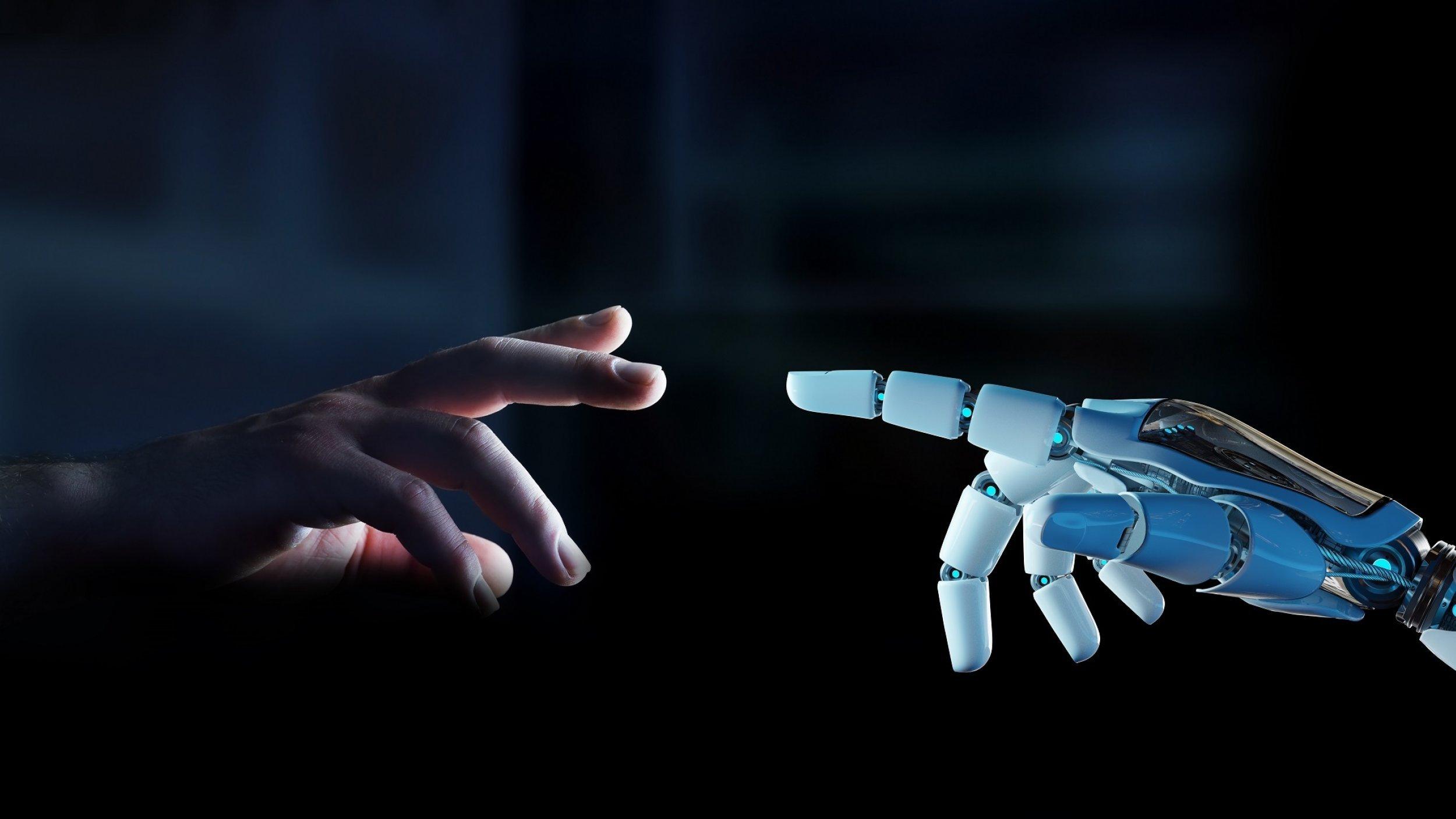 Ein weißer Roboterfinger ist kurz davor, einen menschlichen Finger zu berühren, der sich ihm vor dunklem Hintergrund entgegenstreckt.