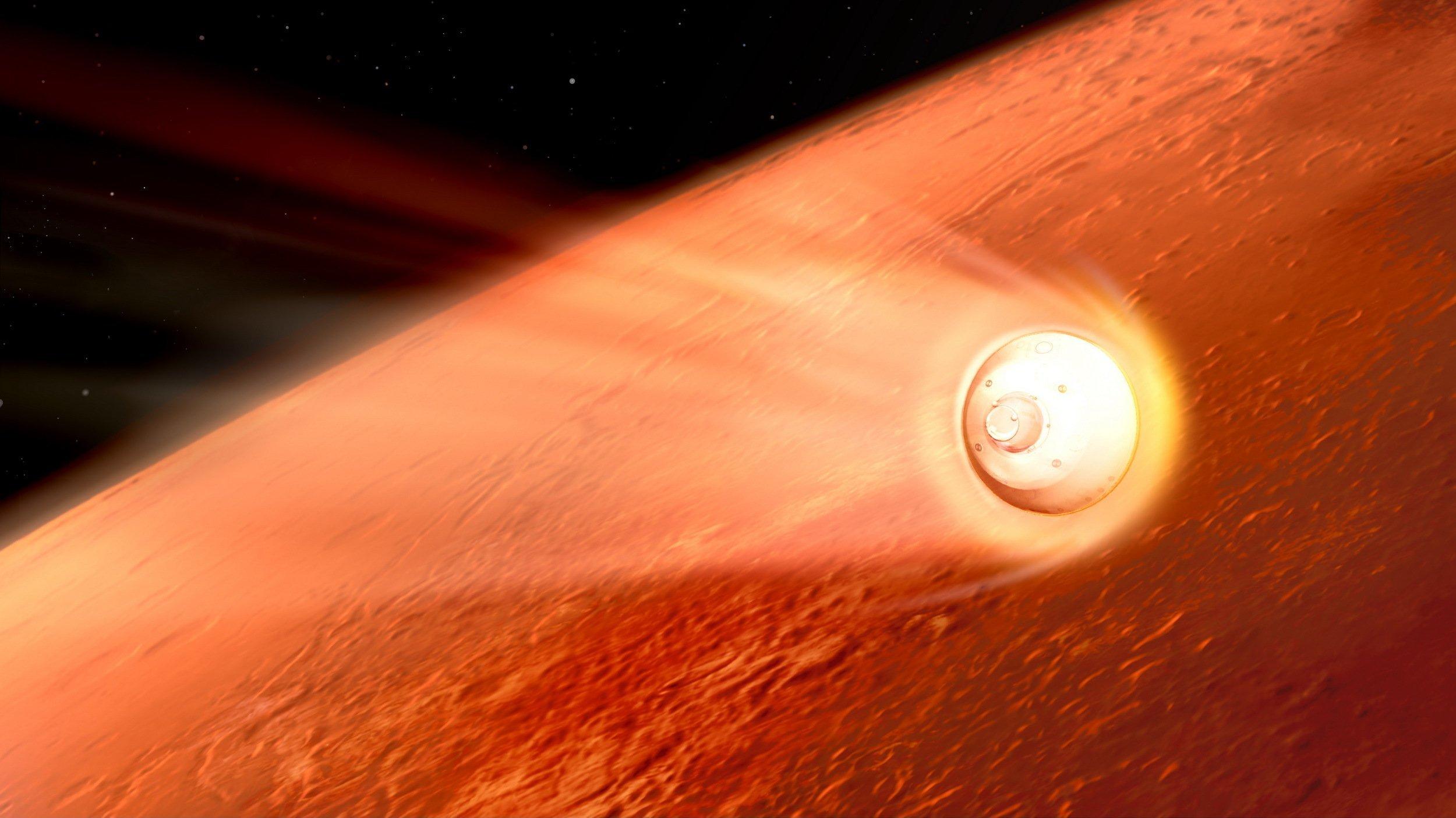 Die künstlerische Darstellung zeigt im Hintergrund einen Ausschnitt des rötlichen Planeten Mars, der zwei Drittel des Bildes einnimmt und sich vor der Schwärze des Weltalls oben links abhebt. Im Vordergrund rast von links kommend die helle Landekapsel einer Raumsonde Richtung Marsoberfläche und zieht dabei einen Schweif erhitzter Gase als Leuchtspur hinter sich her.