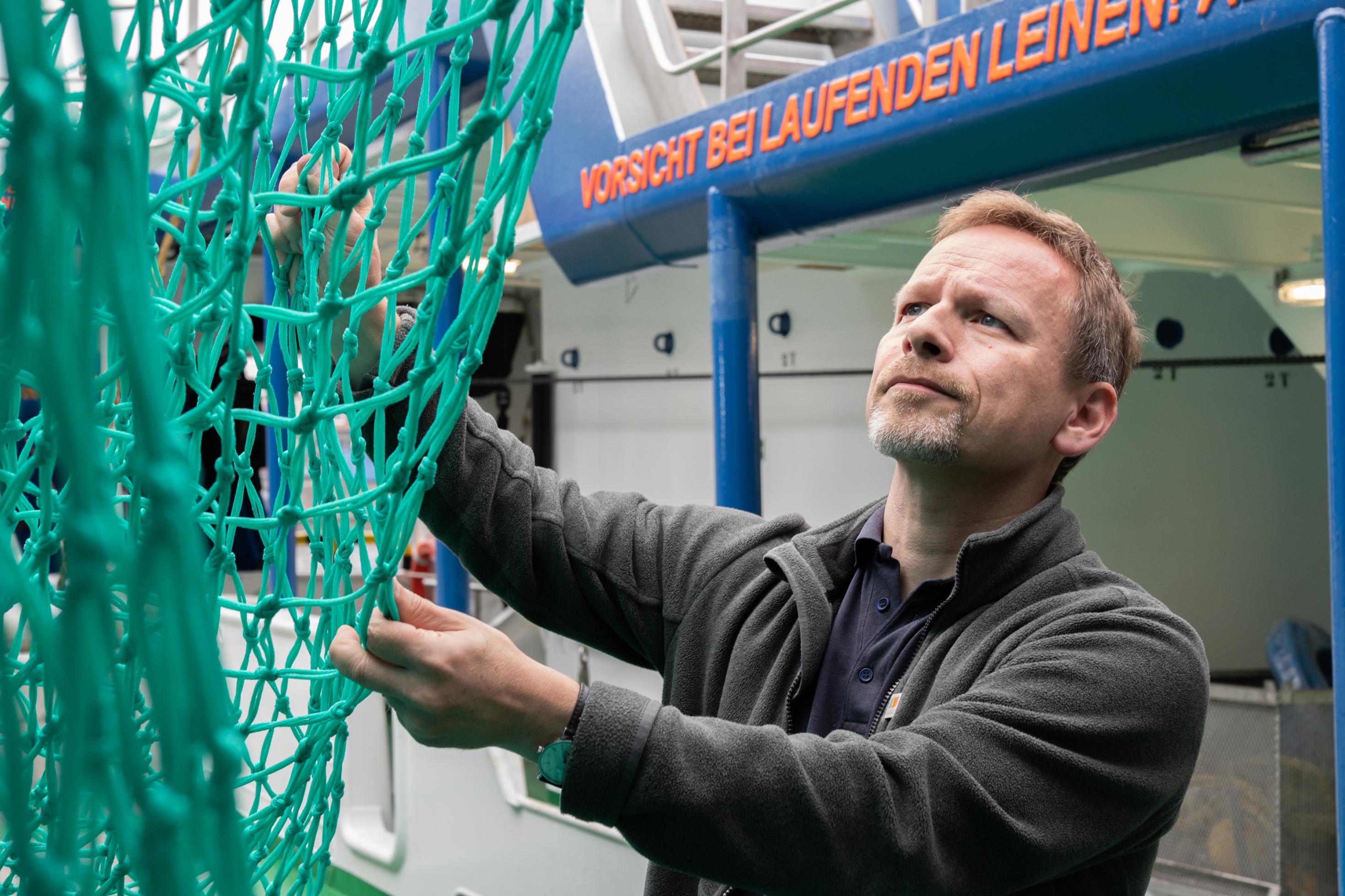 Christopher Zimmermann, Leiter des Instituts für Ostseefischerei am Thünen-Institut, prüft ein Netz.
