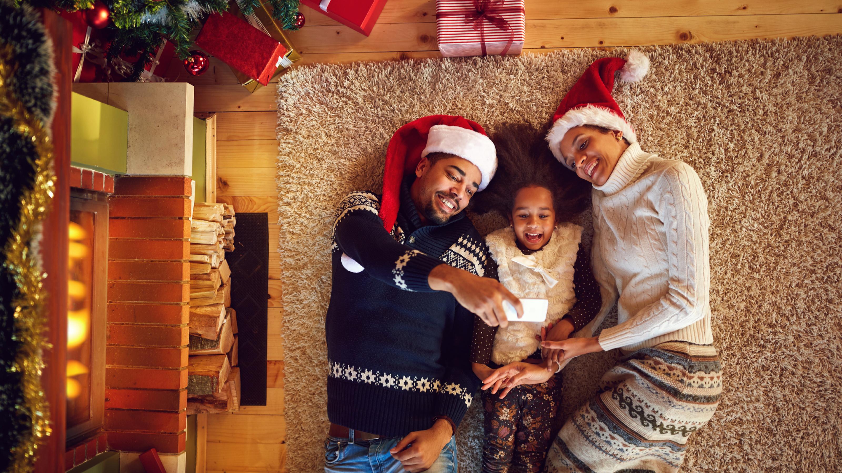 Young afro American family making Christmas selfie
