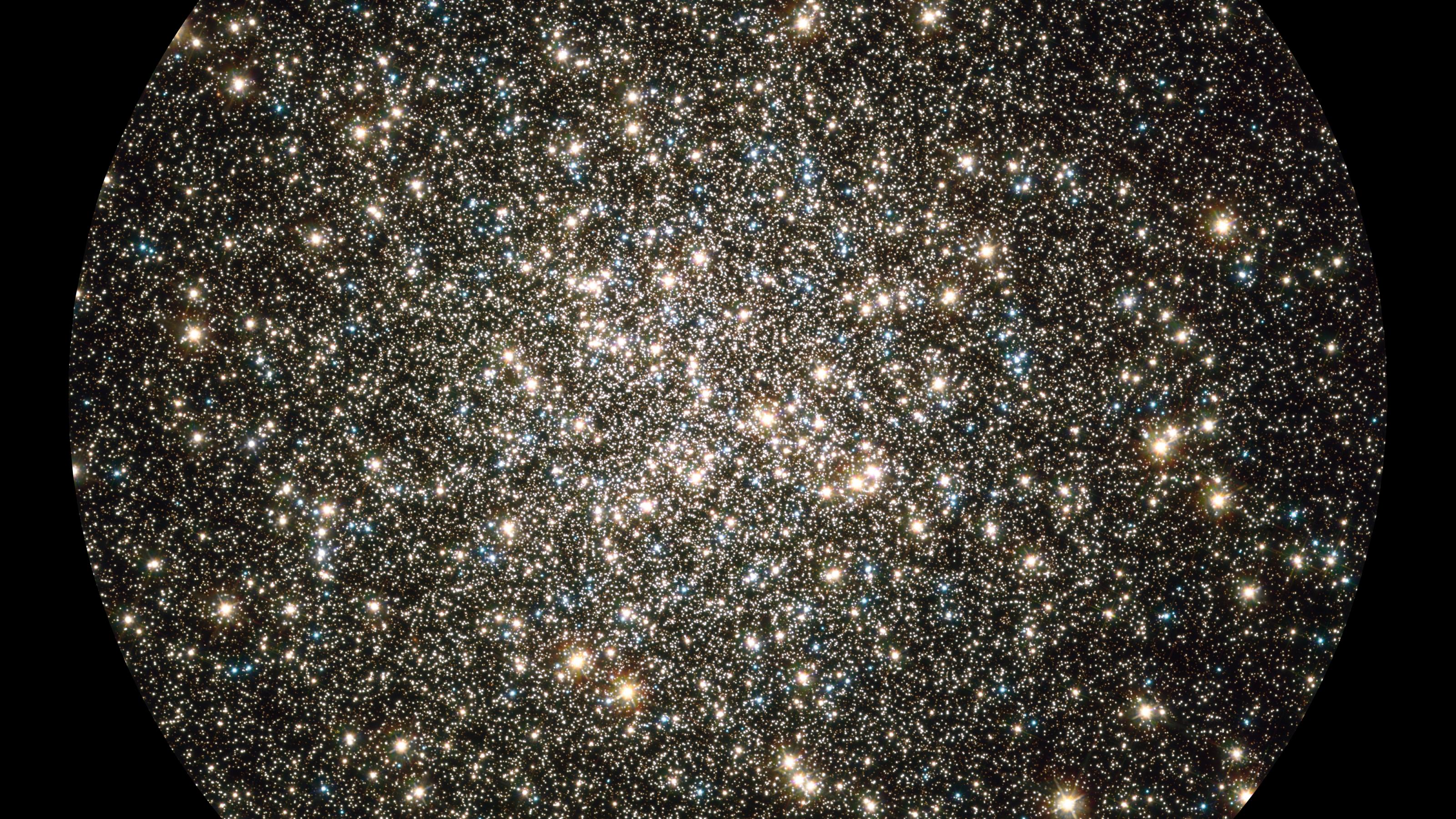 Like a whirl of shiny flakes sparkling in a snow globe, the NASA/ESA Hubble Space Telescope catches an instantaneous glimpse of many hundreds of thousands of stars moving about in the globular cluster M13, one of the brightest and best-known globular clusters in the northern sky. This glittering metropolis of stars is easily found in the winter sky in the constellation Hercules and can even be glimpsed with the unaided eye under dark skies. M13 is home to over 100 000 stars and located at a distance of 25 000 light-years. These stars are packed so closely together in a ball, approximately 150 light-years across, that they will spend their entire lives whirling around in the cluster. This image is a composite of archival Hubble data taken with the Wide Field Planetary Camera 2 and the Advanced Camera for Surveys. Observations from four separate science proposals taken in November 1999, April 2000, August 2005, and April 2006 were used. The image includes broadband filters that isolate light from the blue, visible, and infrared portions of the spectrum.
