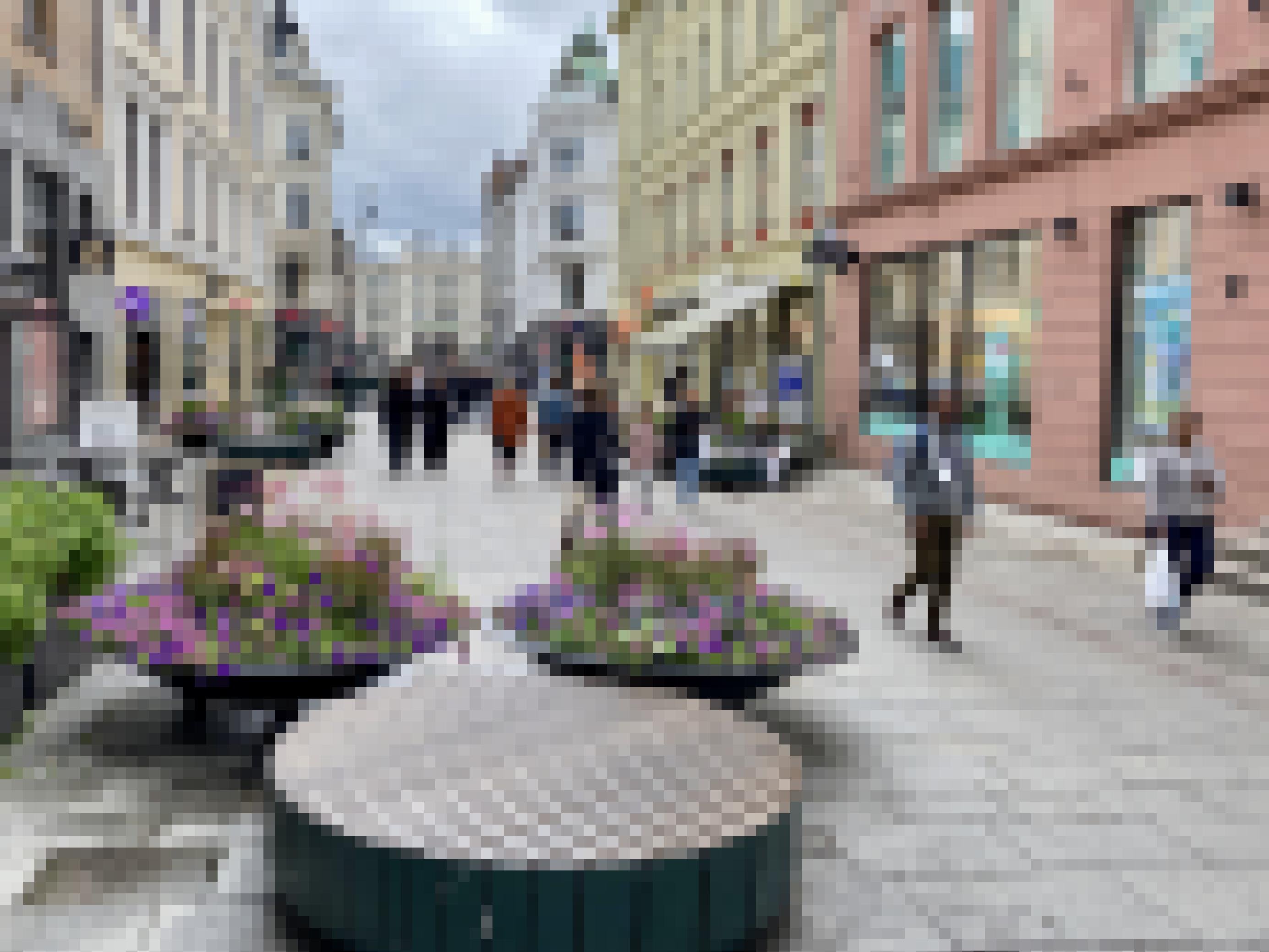In der Fußgängerzone stehen runde Blumenkübel mit runden Sitzgelegenheiten.