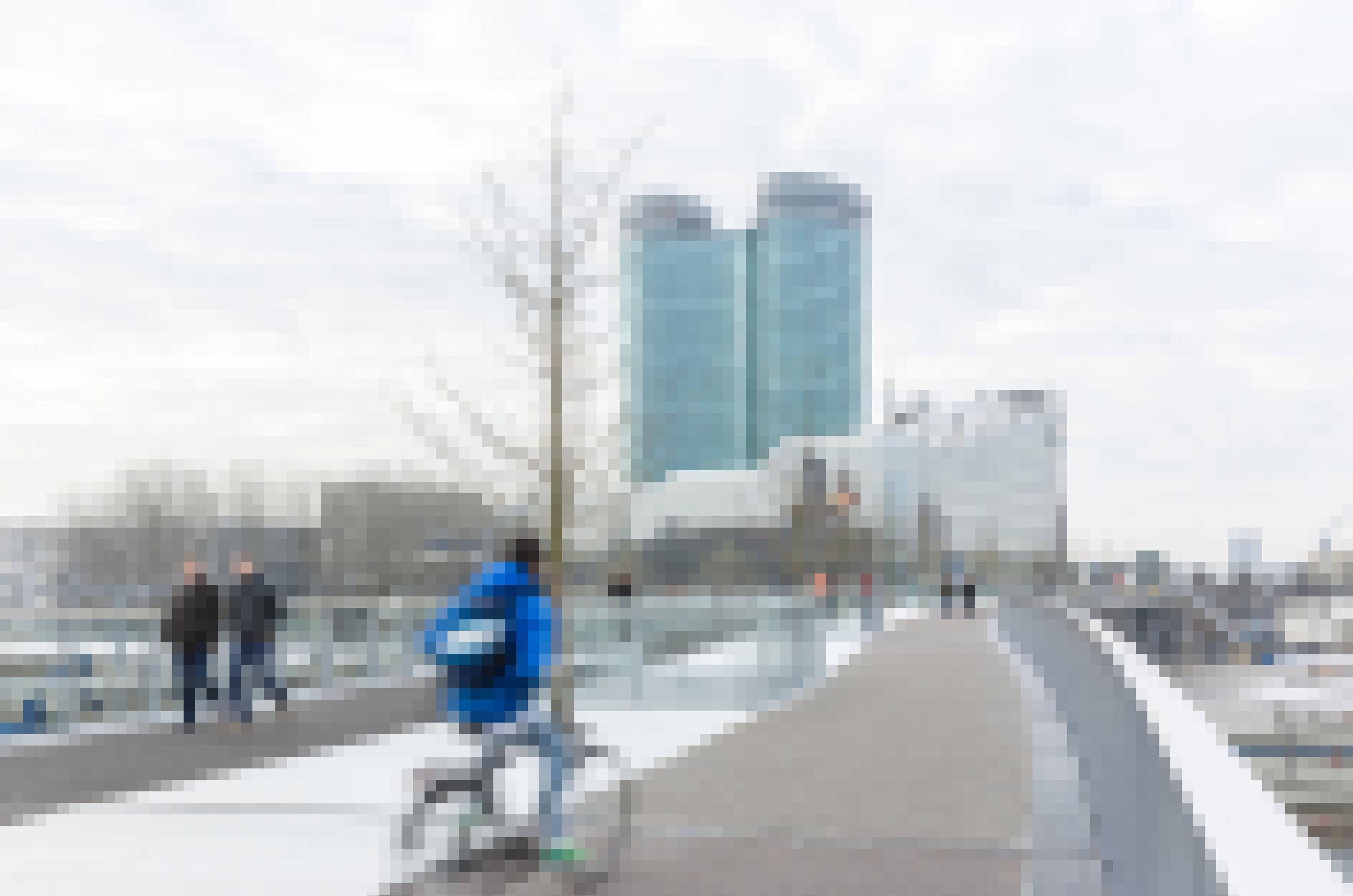 Blick auf die spärlich frequentierte Fußgänger- und Radfahrerbrücke zu einer kalten Jahreszeit bei bedecktem Himmel.