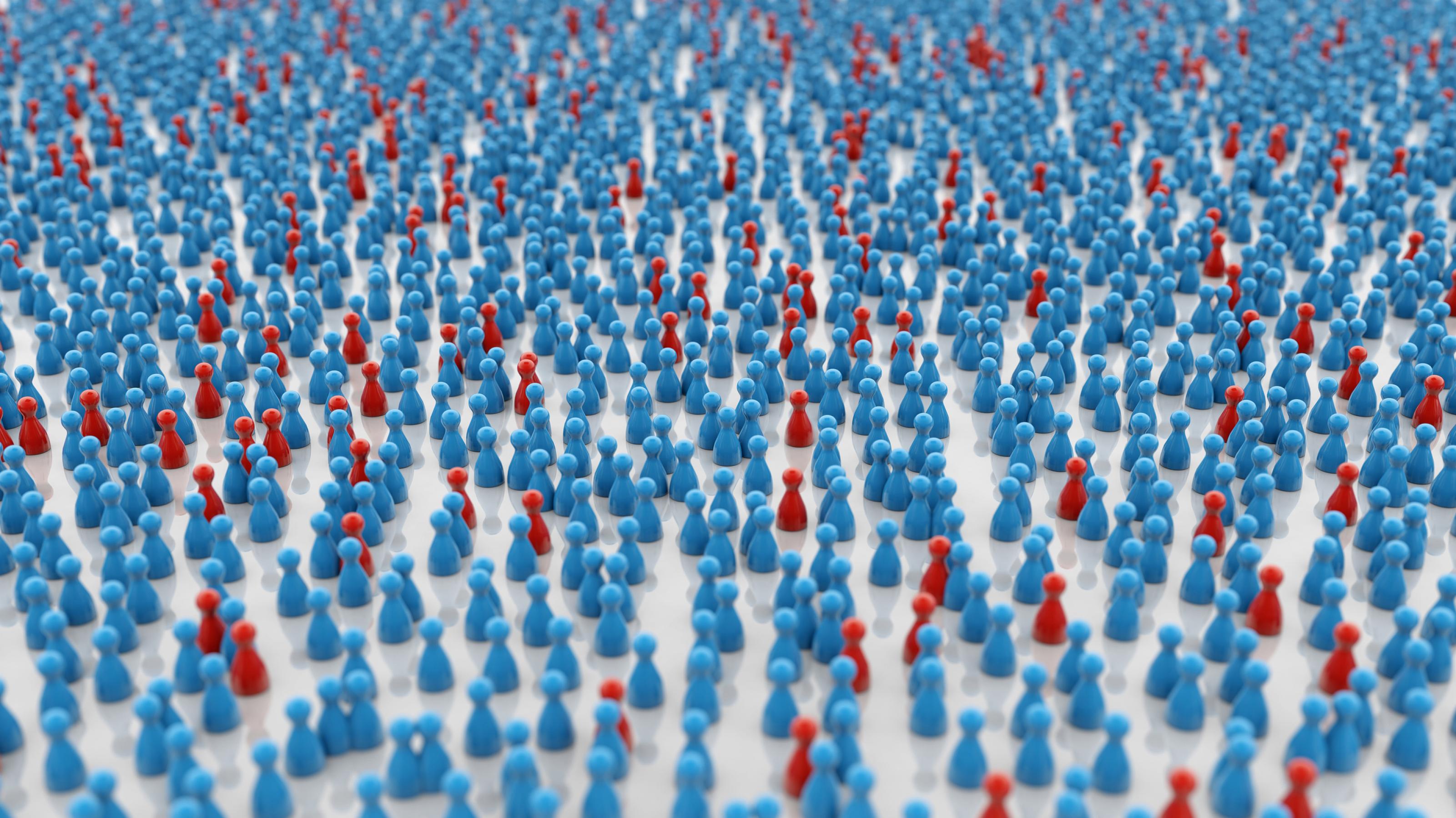 Wenige rote Spielfiguren unter vielen blauen als Sinnbild für die Ausbreitung der Covid-19-Pandemie