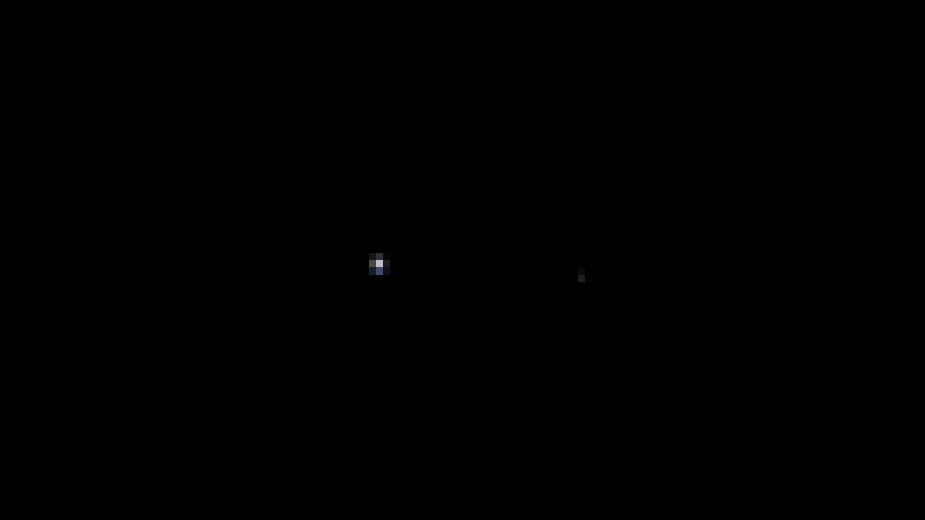 Fast komplett schwarzes Bild. Man kann aber zwei kleine, leuchtende Punkte erkennen.