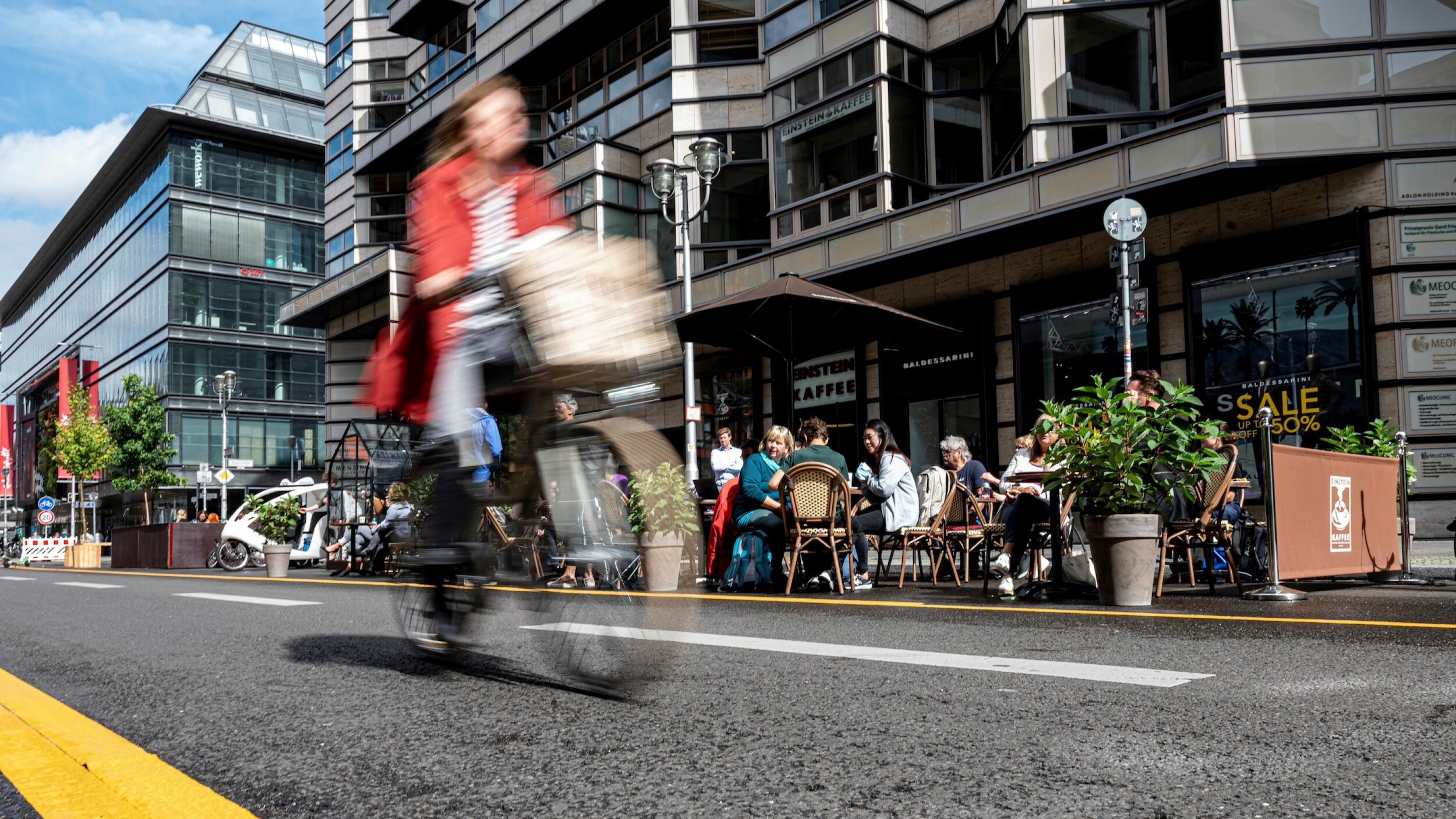 Fahrradfahrer:innen und Passanten
tummeln sich auf dem neuen autofreien Abschnitt der
Friedrichstraße.