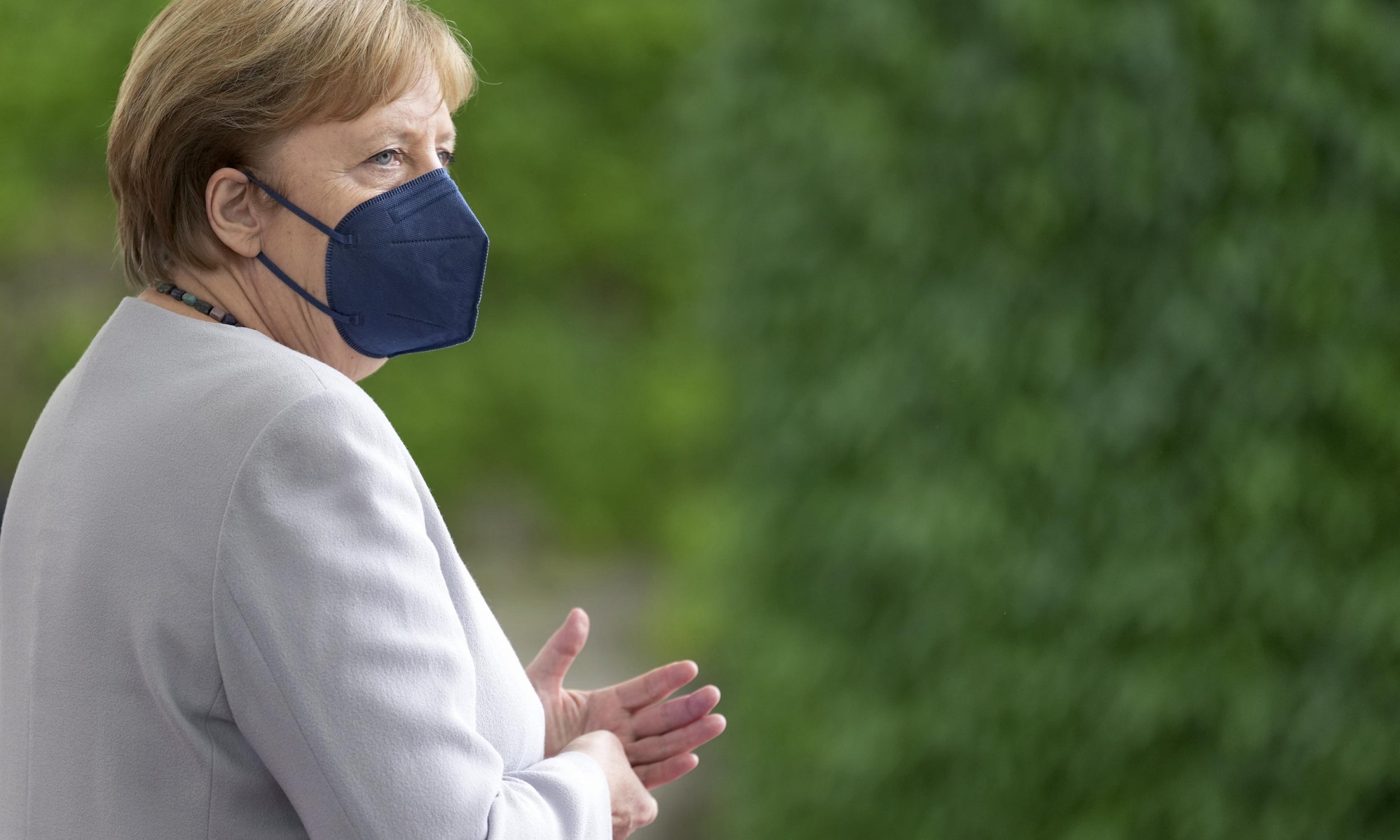 Bundeskanzlerin Angela Merkel vor einer bewachsenen Wand, mit FFP2-Maske