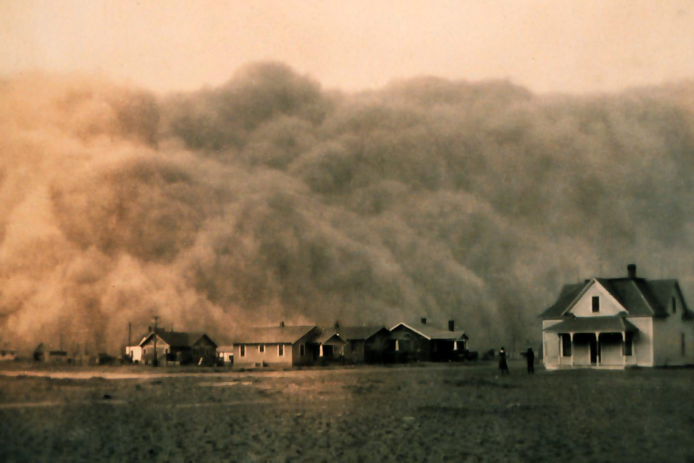 Auf einer historischen Aufnahme aus dem Jahr 1935 sind Häuser der texanischen Stadt Stratford zu sehen, die im Hintergrund von einer herannahenden Staubwolke überragt werden.