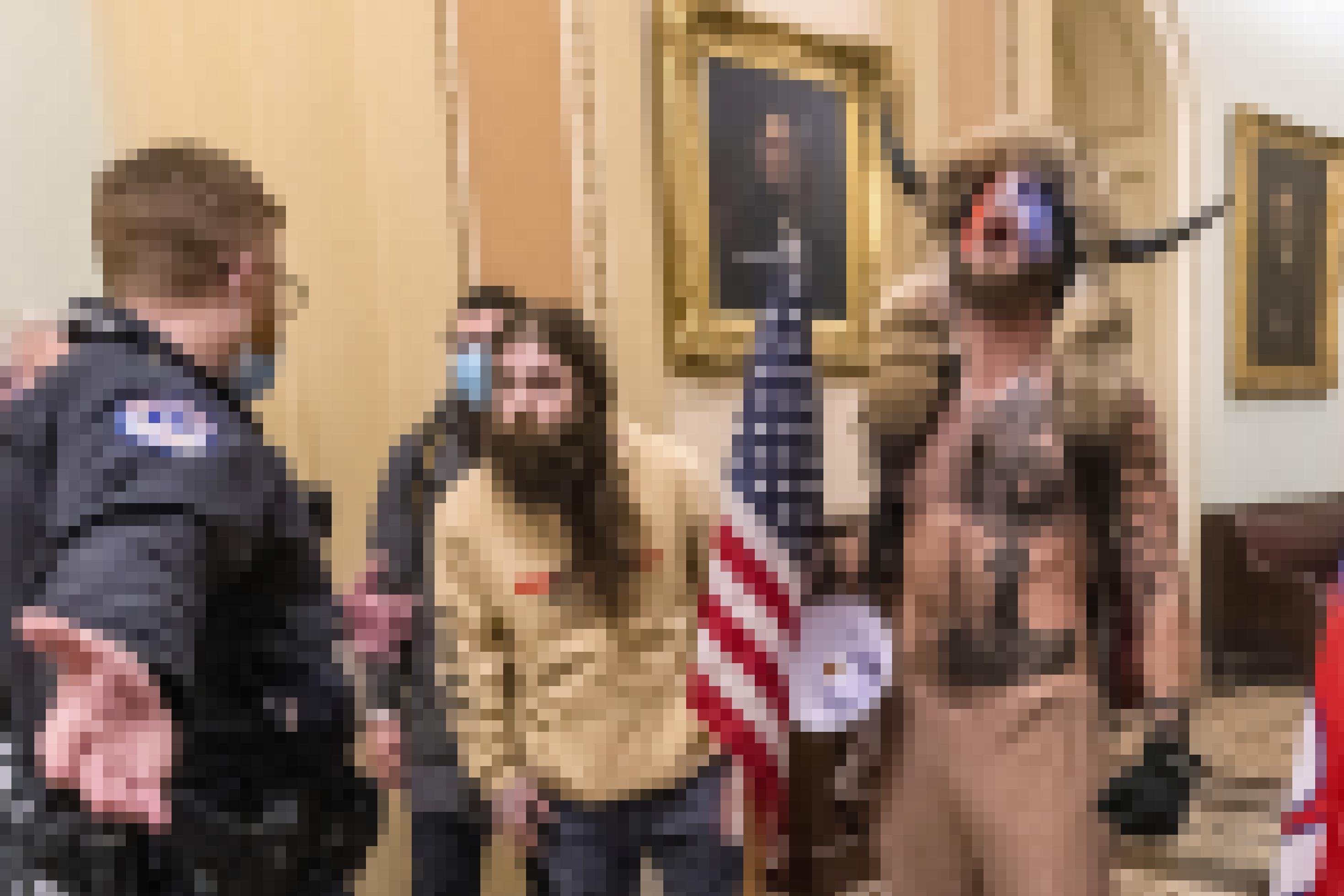 In this Jan. 6, 2021, file photo, is Jacob Chansley, right with fur hat, during the Capitol riot in Washington. Chansley pleaded guilty on Friday, Sept. 3, 2021, to a felony obstruction charge. He carried a flagpole topped with a spear into the insurrection, yelled into a bullhorn as officers tried to control the crowd, posed for photos on the Senate dais and wrote a note to then-Vice President Mike Pence that prosecutors have said was threatening. (AP Photo/Manuel Balce Ceneta, File)