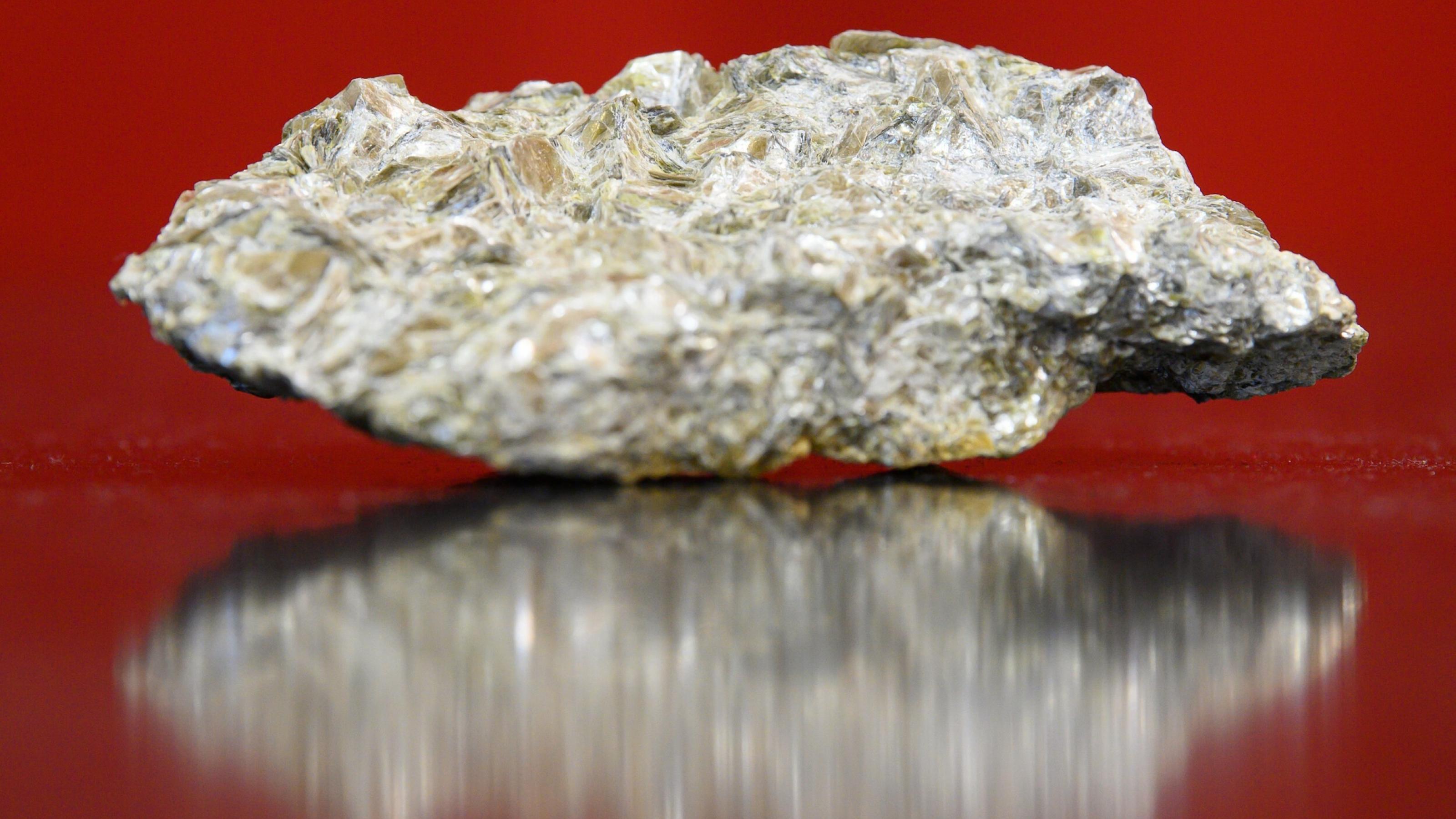 Ein mit Lithium durchzogenes Stück Gestein liegt auf einem Tisch.