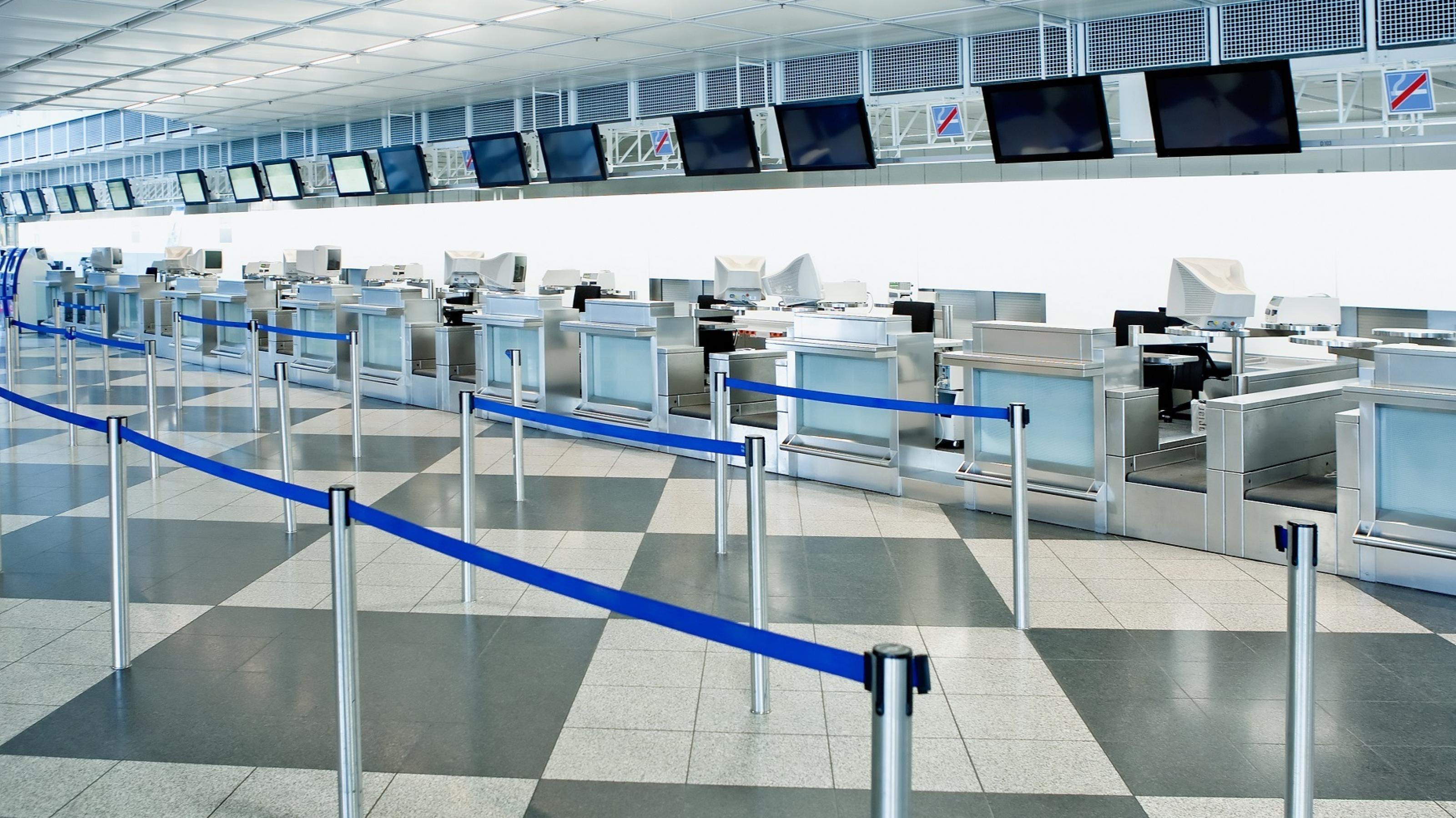 Die öffentliche Check-in-Zone eines Flughafens mit Hindernissen für die Kontrolle der Menschenmenge