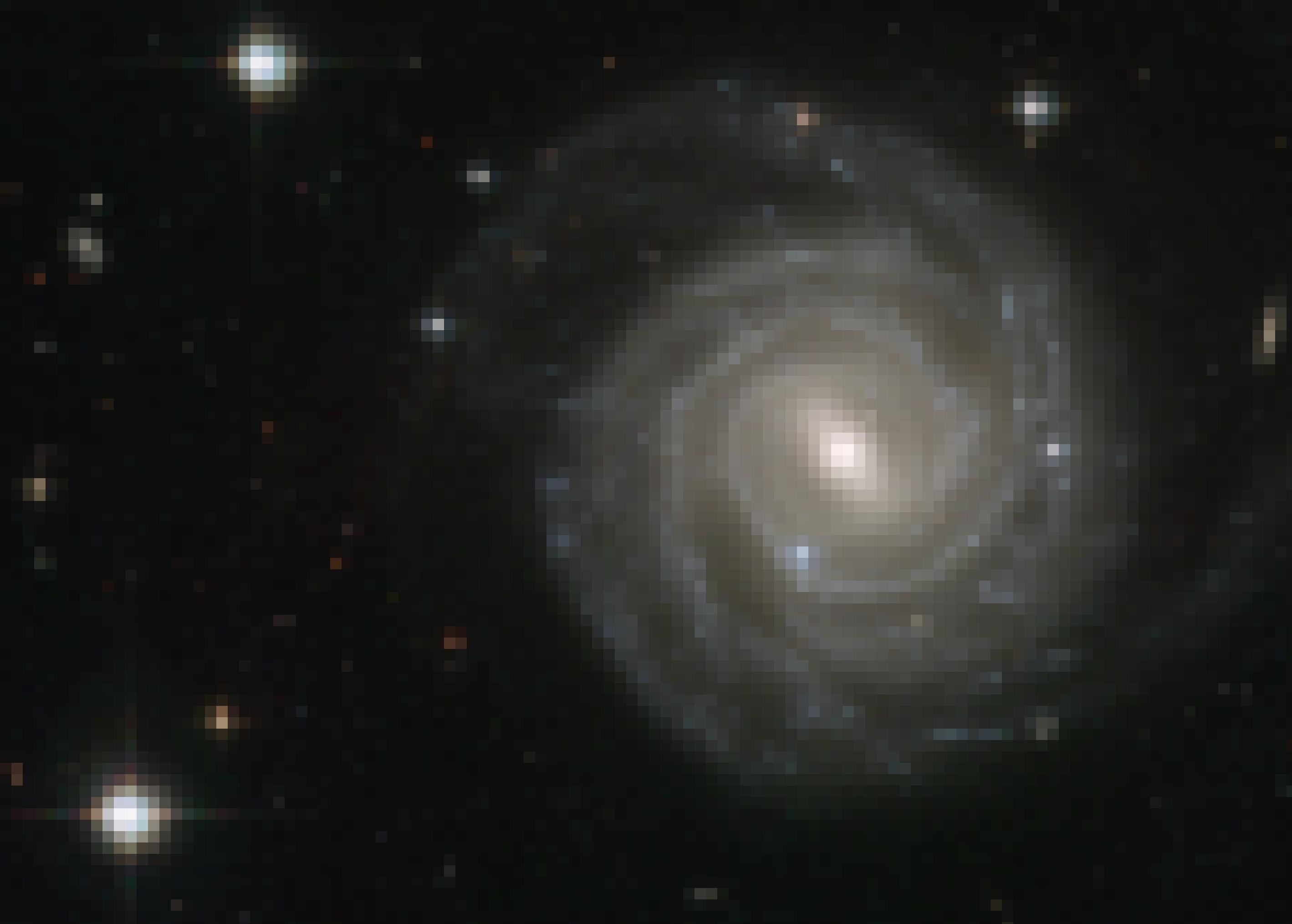 Das Foto zeigt, etwas rechts von der Mitte, die Scheibe einer Spiralgalaxie genau von oben. Die Galaxie wird UGC 12128 genannt und ist im Sternbild Pegasus lokalisiert. Ihr zentraler Bereich, von dem die Spiralarme ausgehen, ist nicht rund, sondern in die Länge gezogen. Deshalb nennen Astronomen diesen Galaxientyp Balkenspirale. Zwei Drittel aller Spiralgalaxien gehören zum Typ Balkenspirale – auch unsere Milchstraße. Einige Wissenschaftler glauben, dass sich Balkenspiralen zu regulären Galaxien entwickeln können. Das Foto wurde vom Hubble-Weltraumteleskop aufgenommen.