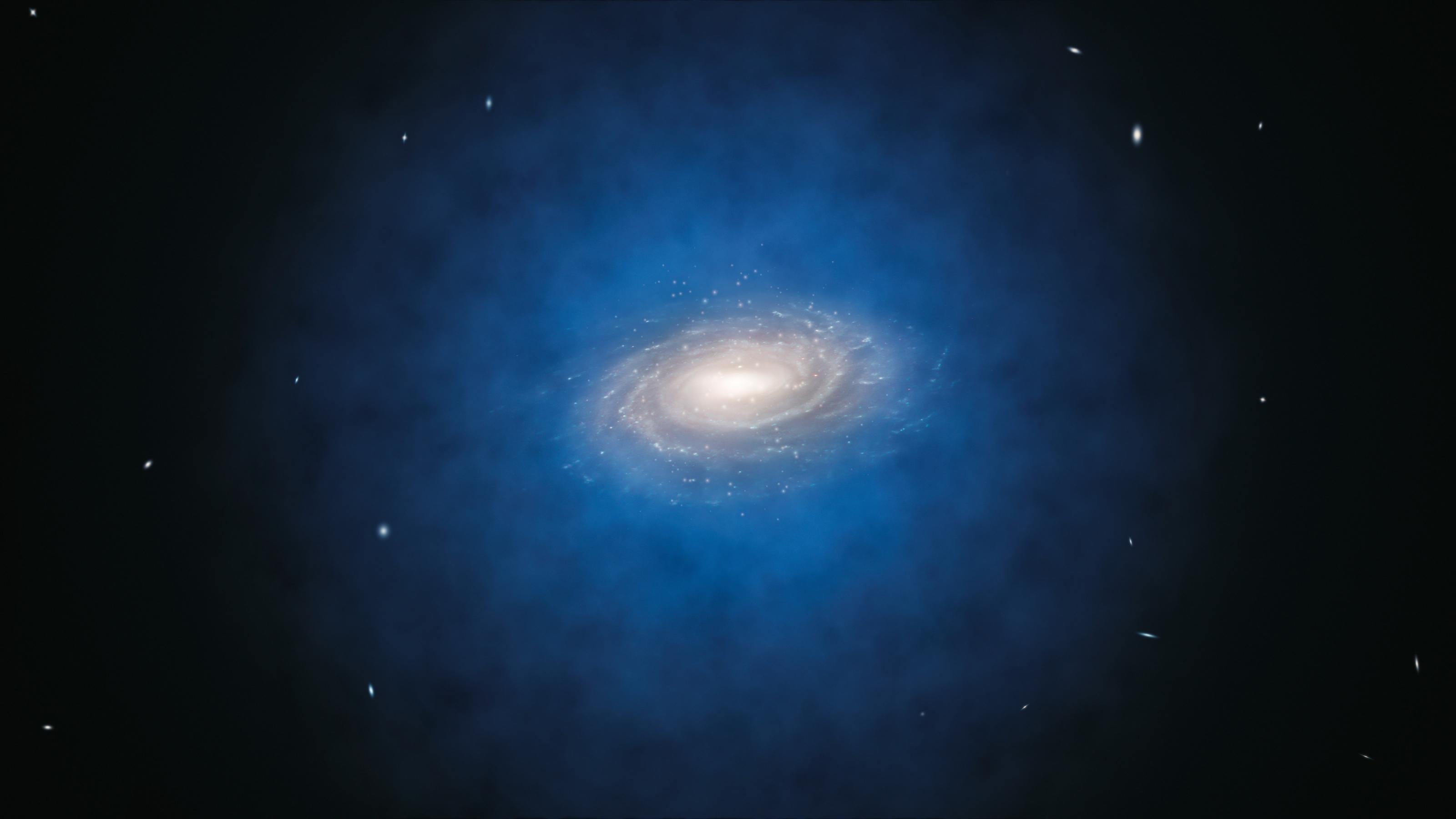 Grafik: Eine Galaxie, die sich mitten in einer blauen diffusen Wolke befindet.