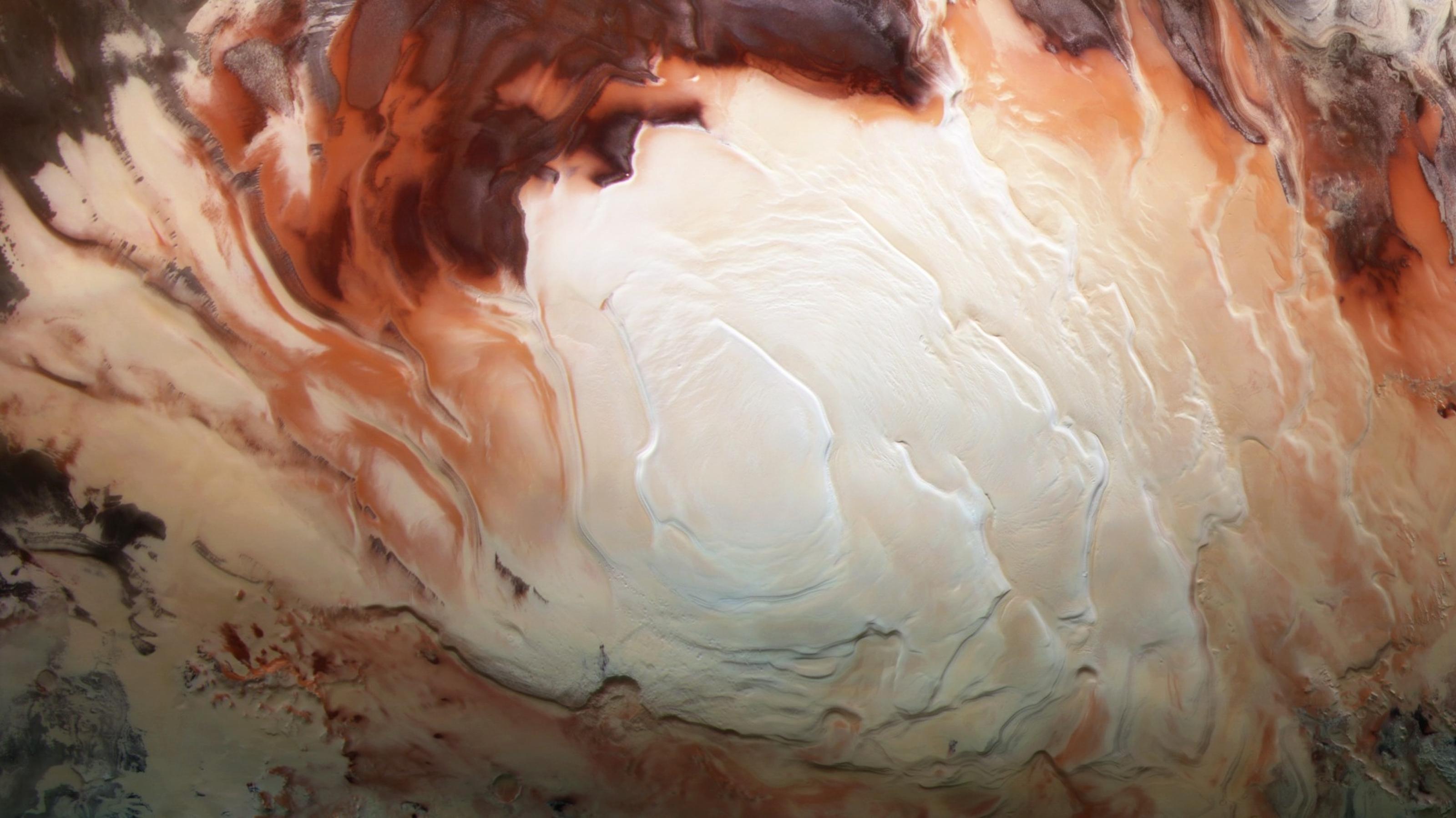 Der Südpol des Mars mit den spiralförmig gedrehten Gletschern wirkt wie der Schaum auf einer Tasse Cappuccino