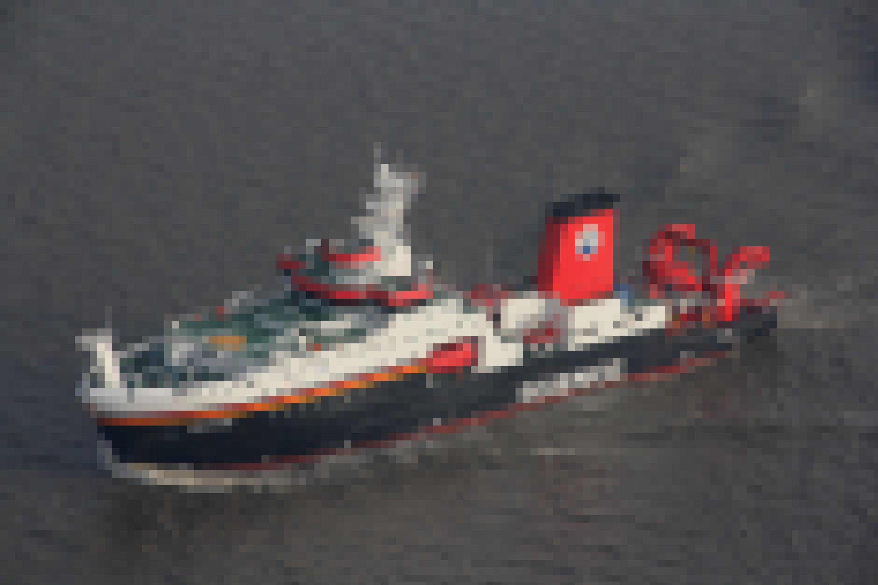 Ein mittelgroßes Schiff in Schwarz. Weiß und Rot, auf dem groß das Wort „Science“ steht.