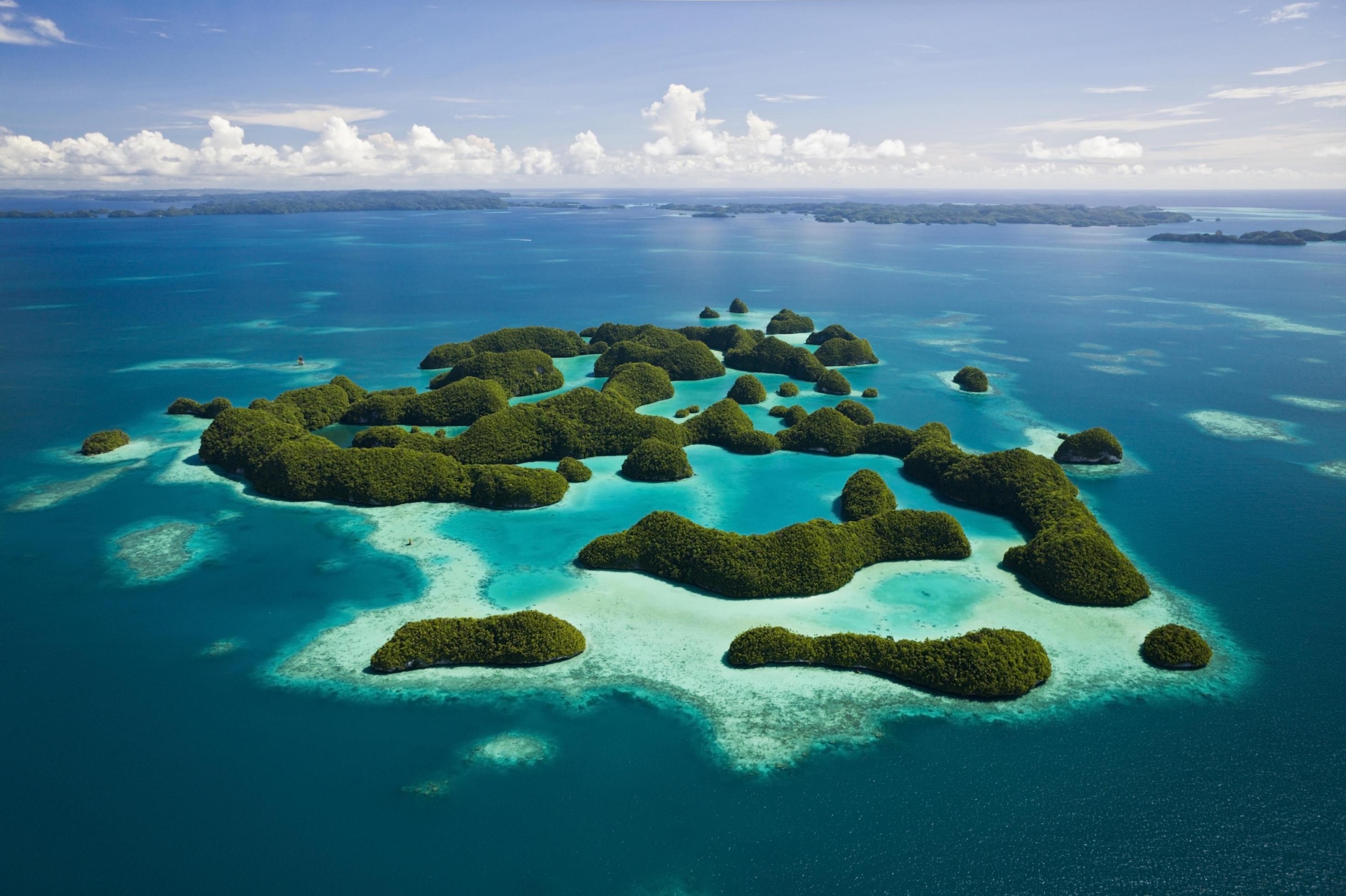 Zu sehen ist ein Luftbild von 70 kleinen Inseln des Pazfikarchipels Palau, umgeben von azurblauem Meer. 78 Prozent der Ausschließlichen Wirtschaftszone stehen unter strengem Schutz