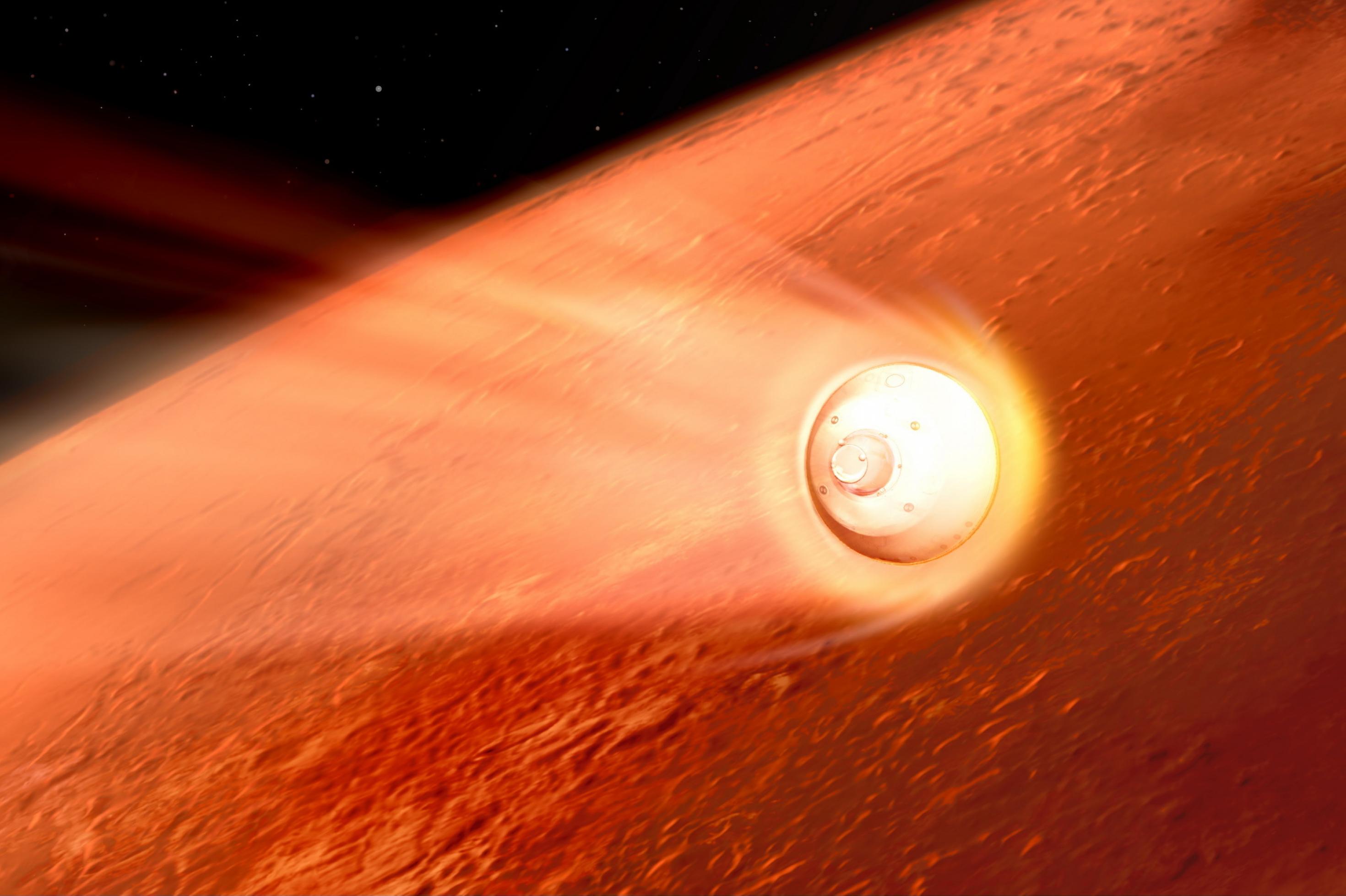 Die künstlerische Darstellung zeigt im Hintergrund einen Ausschnitt des rötlichen Planeten Mars, der zwei Drittel des Bildes einnimmt und sich vor der Schwärze des Weltalls oben links abhebt. Im Vordergrund rast von links kommend die helle Landekapsel einer Raumsonde Richtung Marsoberfläche und zieht dabei einen Schweif erhitzter Gase als Leuchtspur hinter sich her.