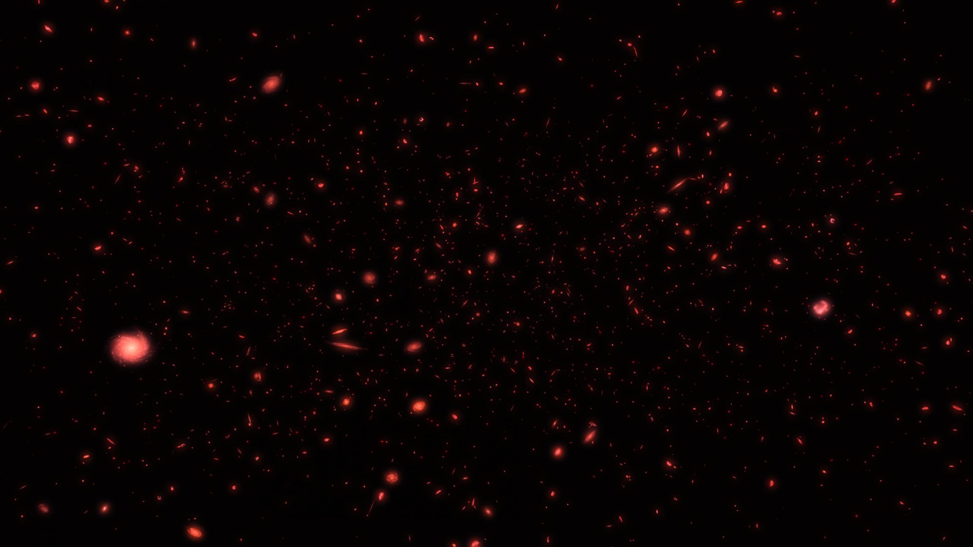 Ein Himmelsausschnitt mit schwachen, roten Galaxien