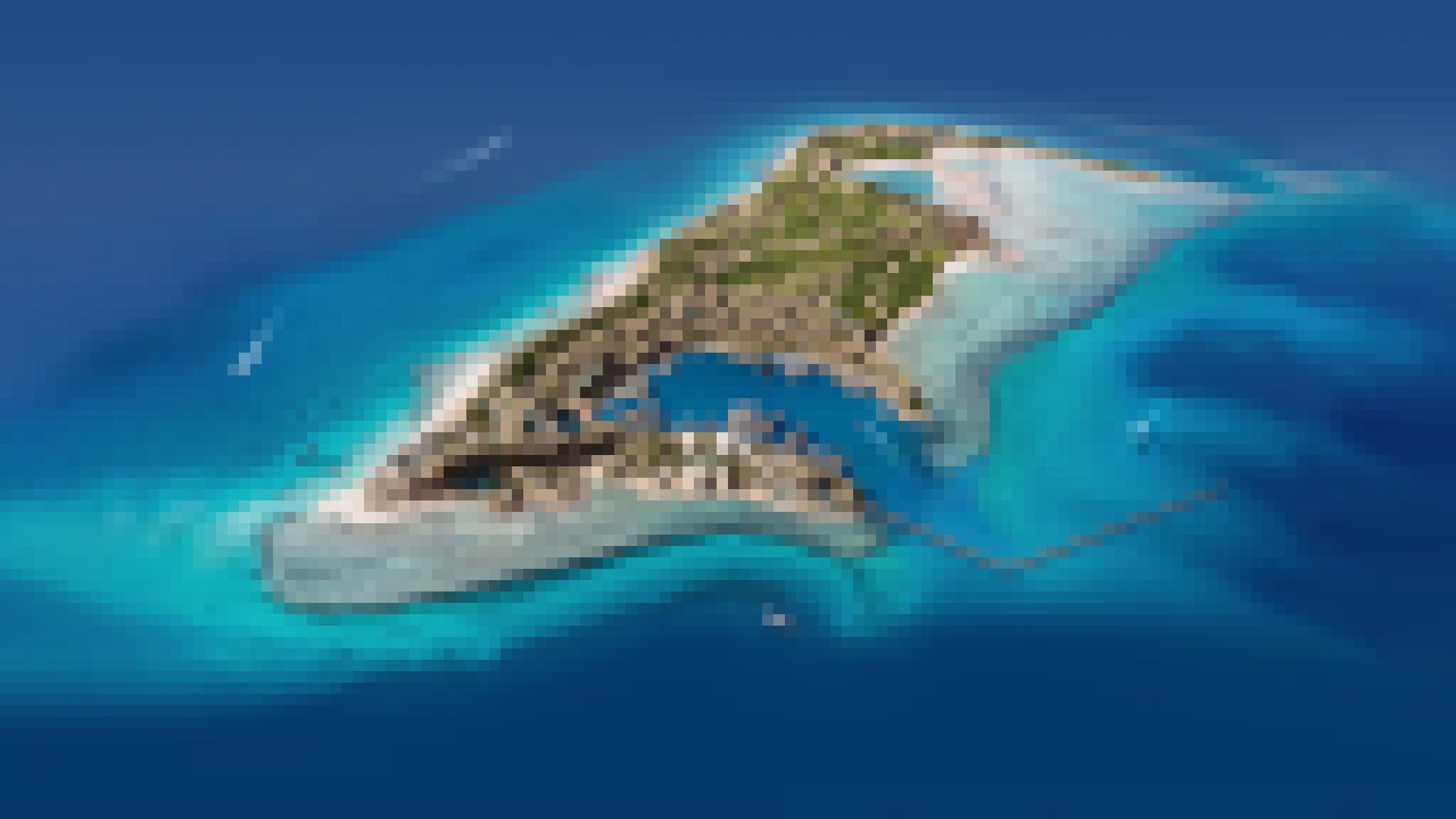 Man sieht die geplante Insel Sindalah aus der Vogelperspektive. Sie liegt im blauen Meerwasser.