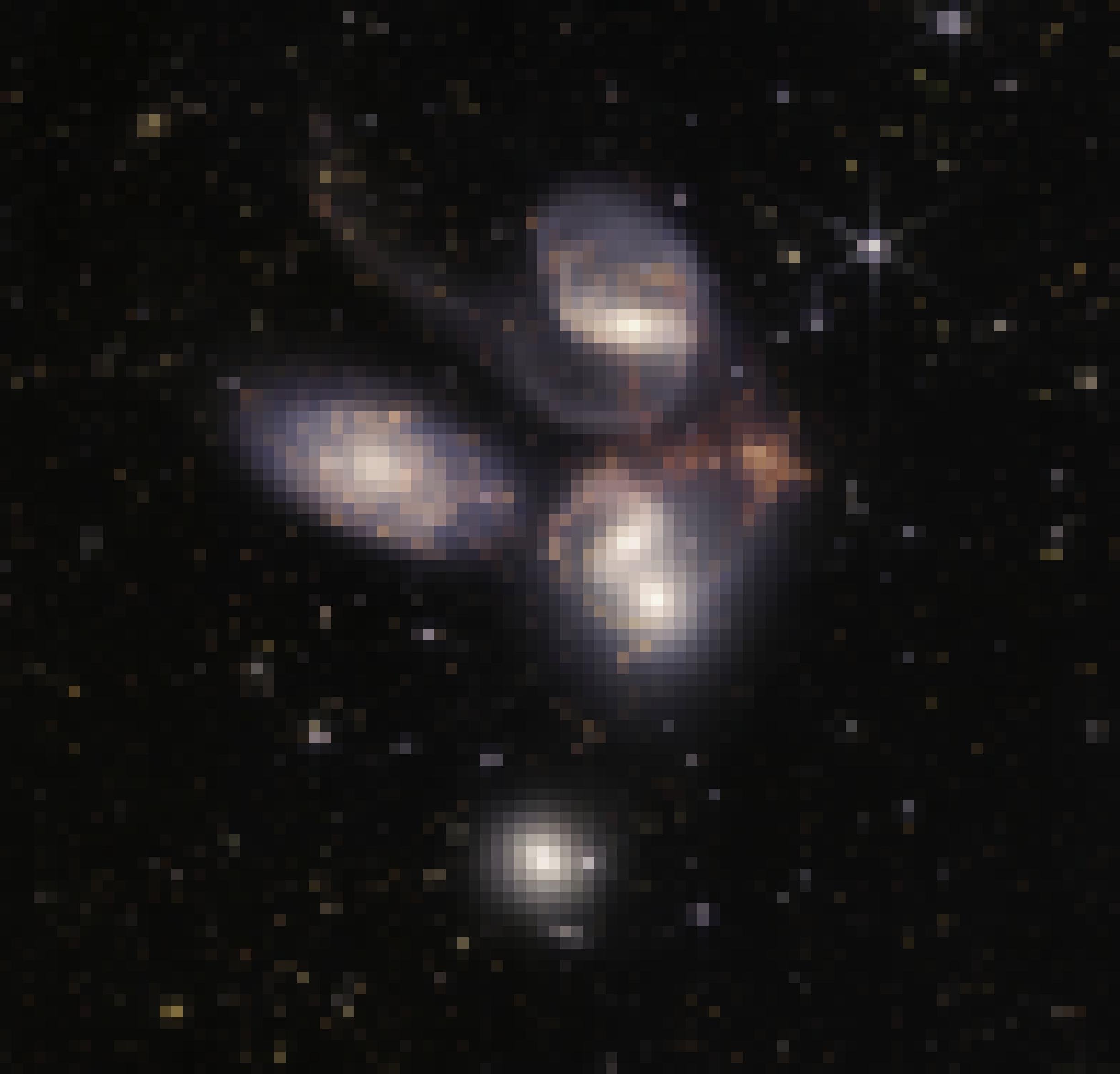 In dem Bild sind fünf dicht beieinander stehende Galaxien zu sehen. Das Infrarote ist farblich sichtbar gemacht.