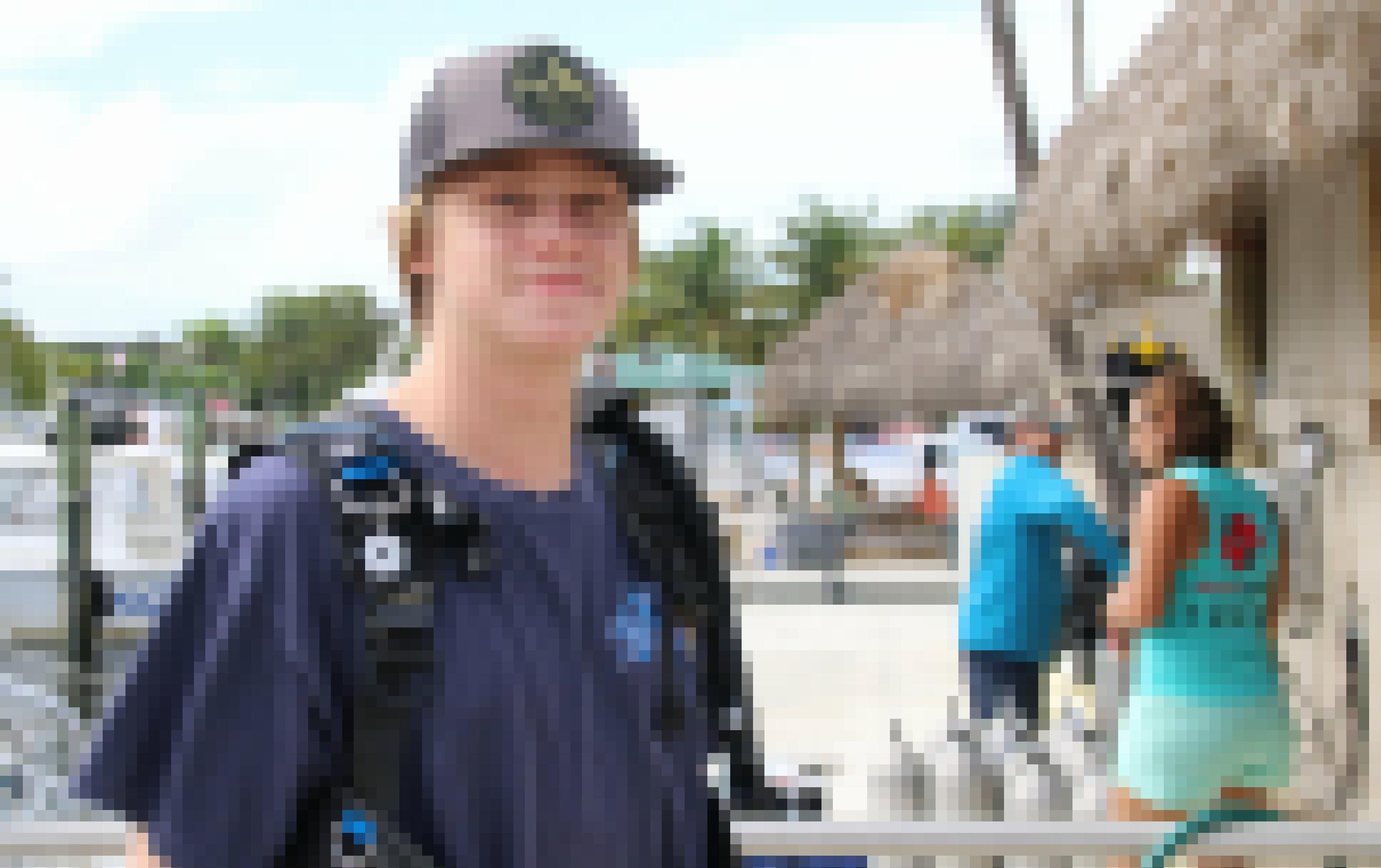 Der Schüler Hugh La Fontisee steht mit Taucherflaschen auf dem Rücken an einem Strand in Florida.